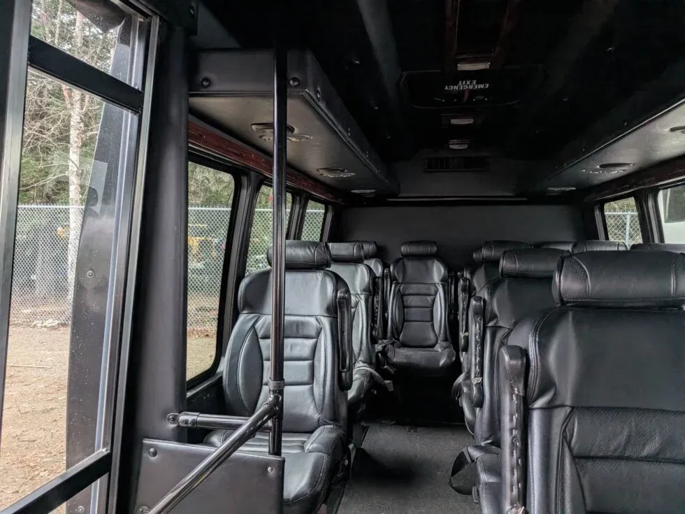 Interior of the private luxury tour van with leather captain's seats